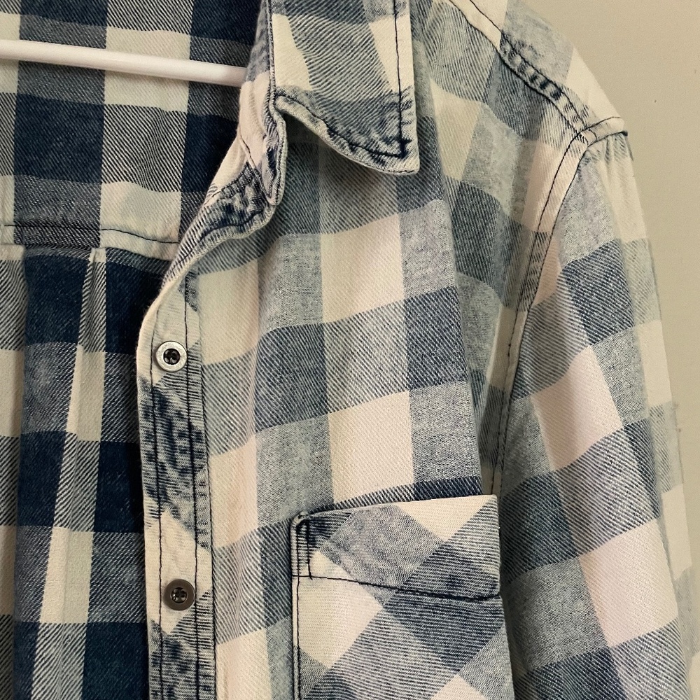Blue and white checked button up shirt.